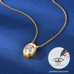 Gold necklace with a teardrop-shaped pendant on a blue background