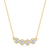 Gold necklace with four round diamonds on a white background