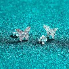 Butterfly-shaped silver earrings on a turquoise glittery background Butterfly Earrings for Women S925 Sterling Silver Moissanite Aru collection