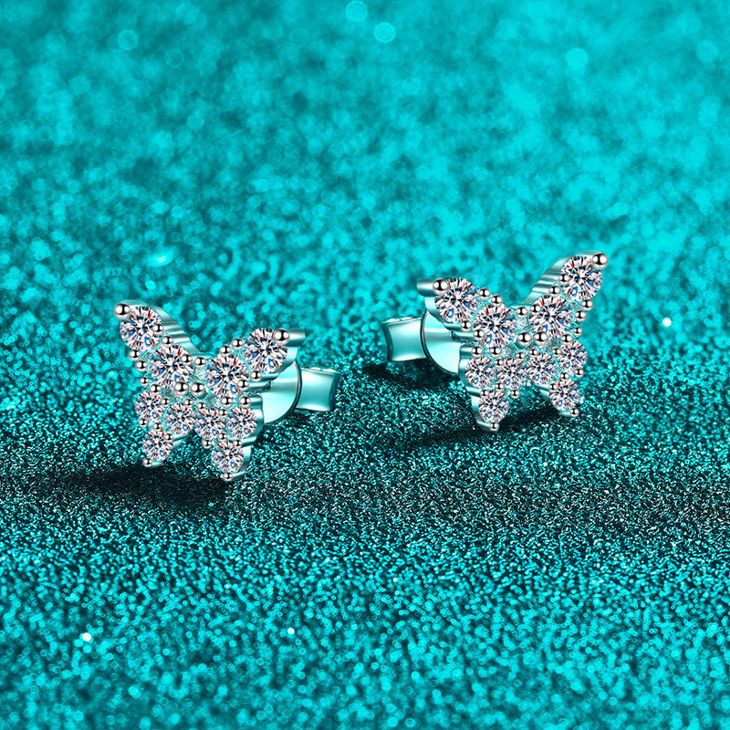 Butterfly-shaped earrings on a teal glittery background Butterfly Earrings for Women S925 Sterling Silver Moissanite Aru collection