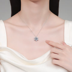 Necklace with a star-shaped pendant worn by a model, with a hand pointing to it. Heart Hexagonal Pendant Necklace with Moissanite Sterling Silver Aru Collection
