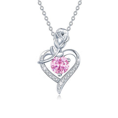 Silver necklace with a pink gemstone heart pendant on a white background