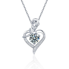 Silver heart-shaped necklace with a central gemstone on a white background