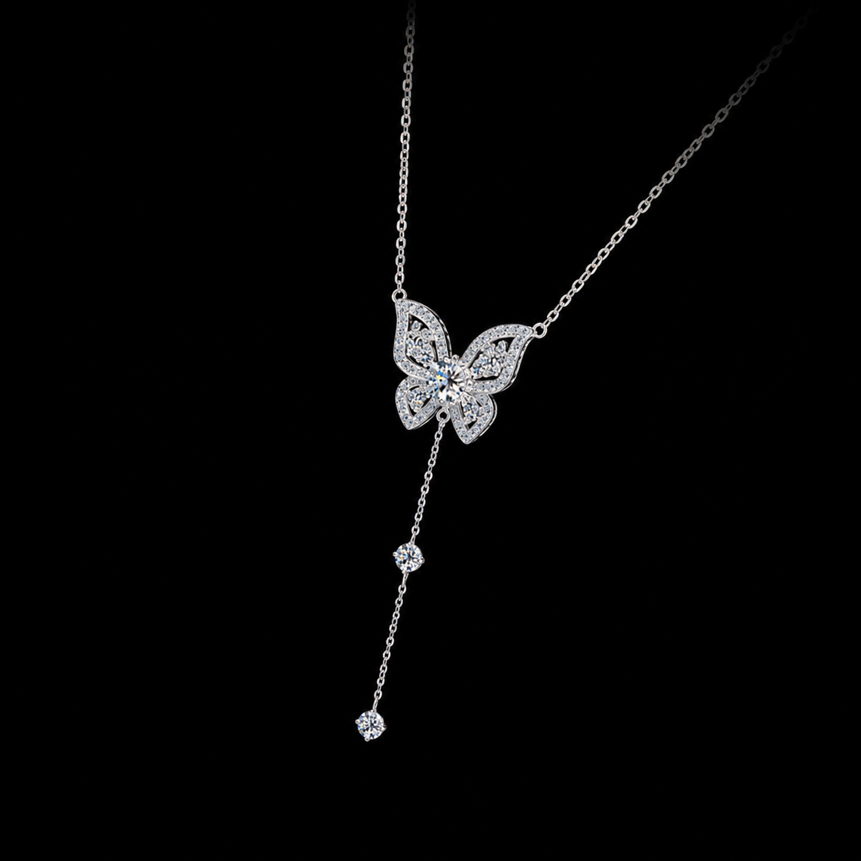Butterfly-shaped necklace with dangling elements on a black background