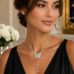 Woman wearing a butterfly necklace in an elegant indoor setting