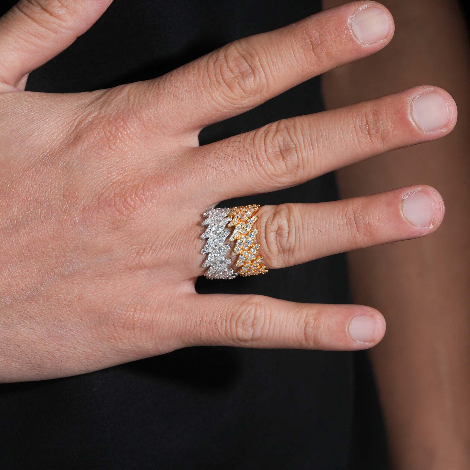 Hand wearing a diamond ring with a blurred background