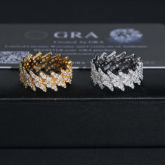 Two gold and silver bracelets on a black surface with 'GRA' branding in the background.