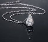 Silver necklace with a teardrop-shaped pendant on a dark background, featuring the brand 'Zuanfa'.