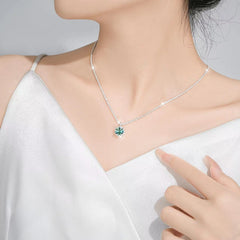 Green moissanite pendant necklace worn with white top