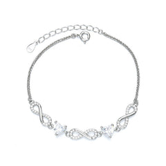 Silver bracelet with infinity symbols and clear stones on a white Aru Collection background