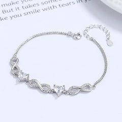 Silver bracelet with heart-shaped charms on a white background Silver bracelet with infinity symbols Aru Collection