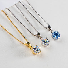 Pair of moissanite pendant necklaces in gold and silver