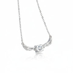 Silver necklace with a winged pendant on a blue textured background angel wing design Silver necklace Aru collection 1