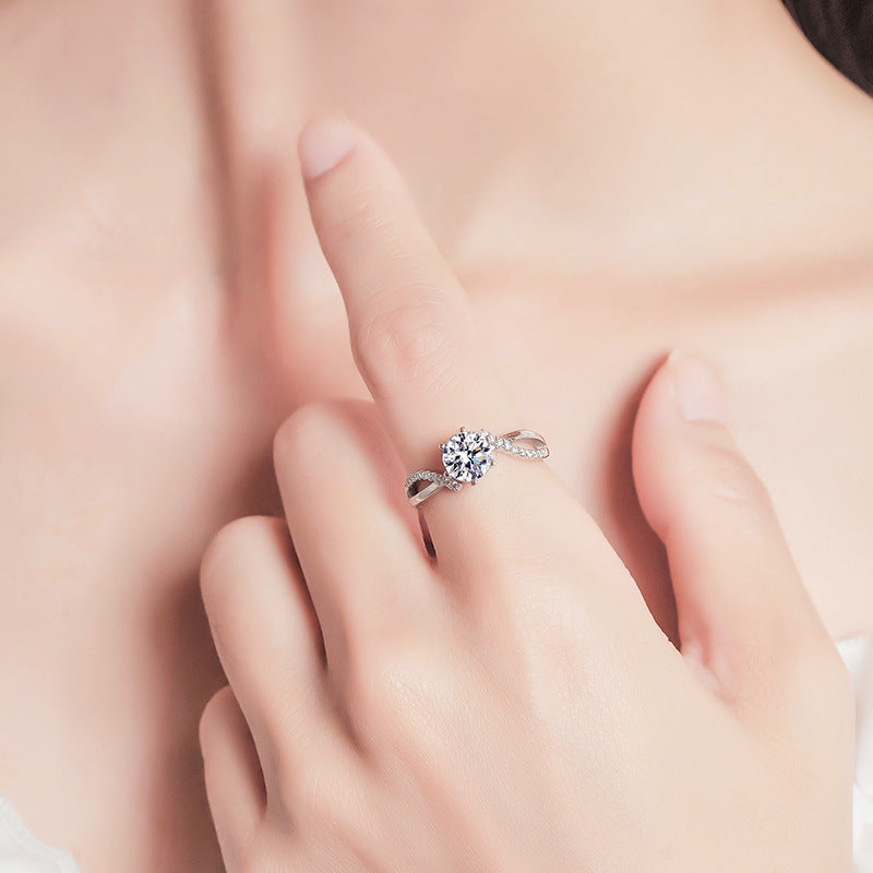 Cross moissanite ring close-up, six-claw setting