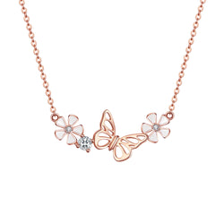 Rose gold butterfly and flower necklace on a light gray background