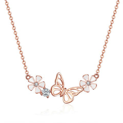 Rose gold butterfly necklace with flowers on a white background