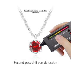 Red moissanite pendant tested with diamond pen - passes authenticity