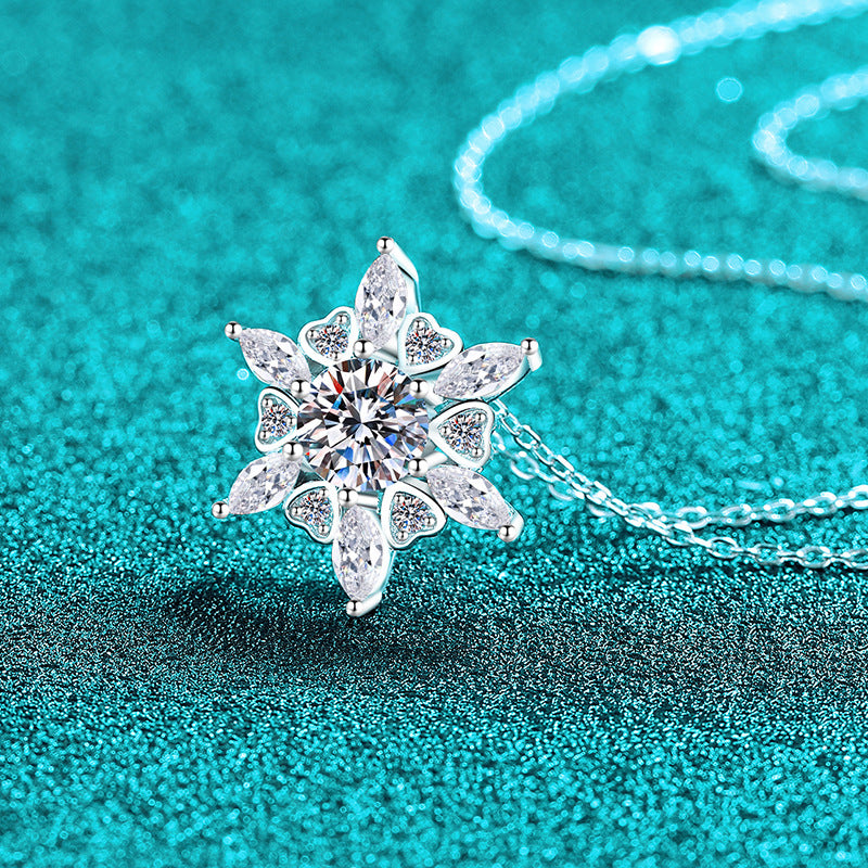 Silver snowflake-shaped pendant on a turquoise background Heart Hexagonal Pendant Necklace with Moissanite Sterling Silver Aru Collection 