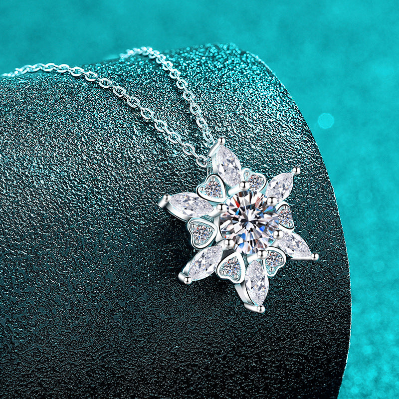 Silver necklace with a star-shaped pendant on a dark surface with a teal background  Heart Hexagonal Pendant Necklace with Moissanite Sterling Silver Aru Collection 