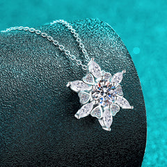Silver necklace with a star-shaped pendant on a dark surface with a teal background  Heart Hexagonal Pendant Necklace with Moissanite Sterling Silver Aru Collection 