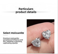Heart-shaped moissanite earrings on a finger with product details text.