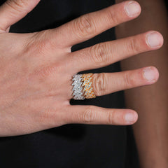 Hand wearing a diamond ring with a blurred background