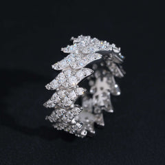 Silver ring with multiple layers of diamonds on a black background