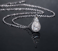 Silver necklace with a teardrop-shaped pendant on a dark background, featuring the brand 'Zuanfa'.