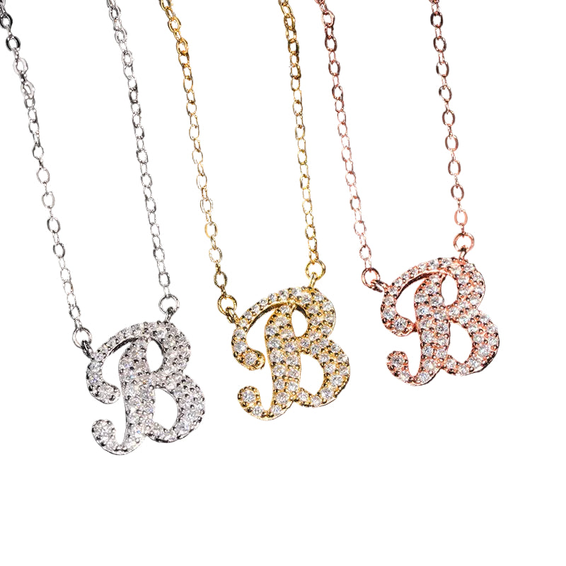 Three letter 'B' necklaces in different colors on a black background