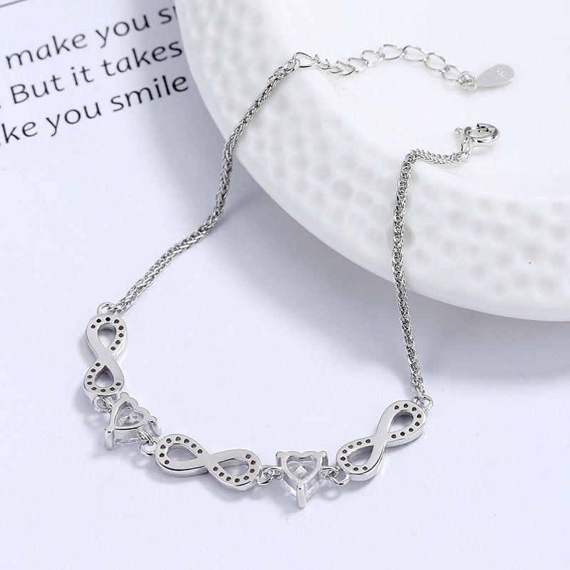 Silver bracelet with unique links on a white surface Silver bracelet with infinity symbols  Aru Collection