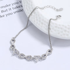 Silver bracelet with unique links on a white surface Silver bracelet with infinity symbols  Aru Collection