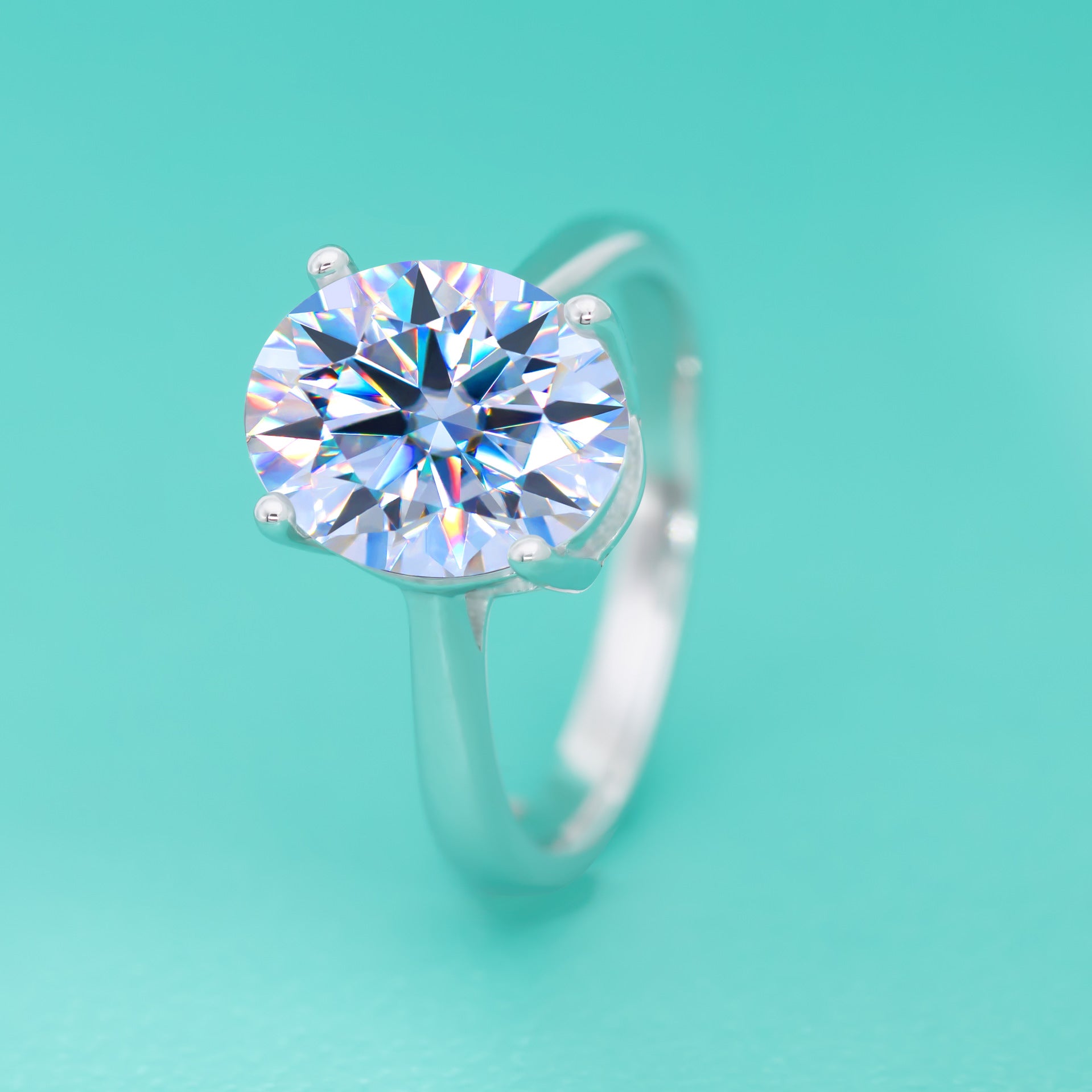 Silver ring with a large diamond on a turquoise background