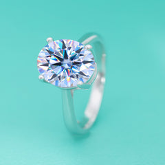 Silver ring with a large diamond on a turquoise background