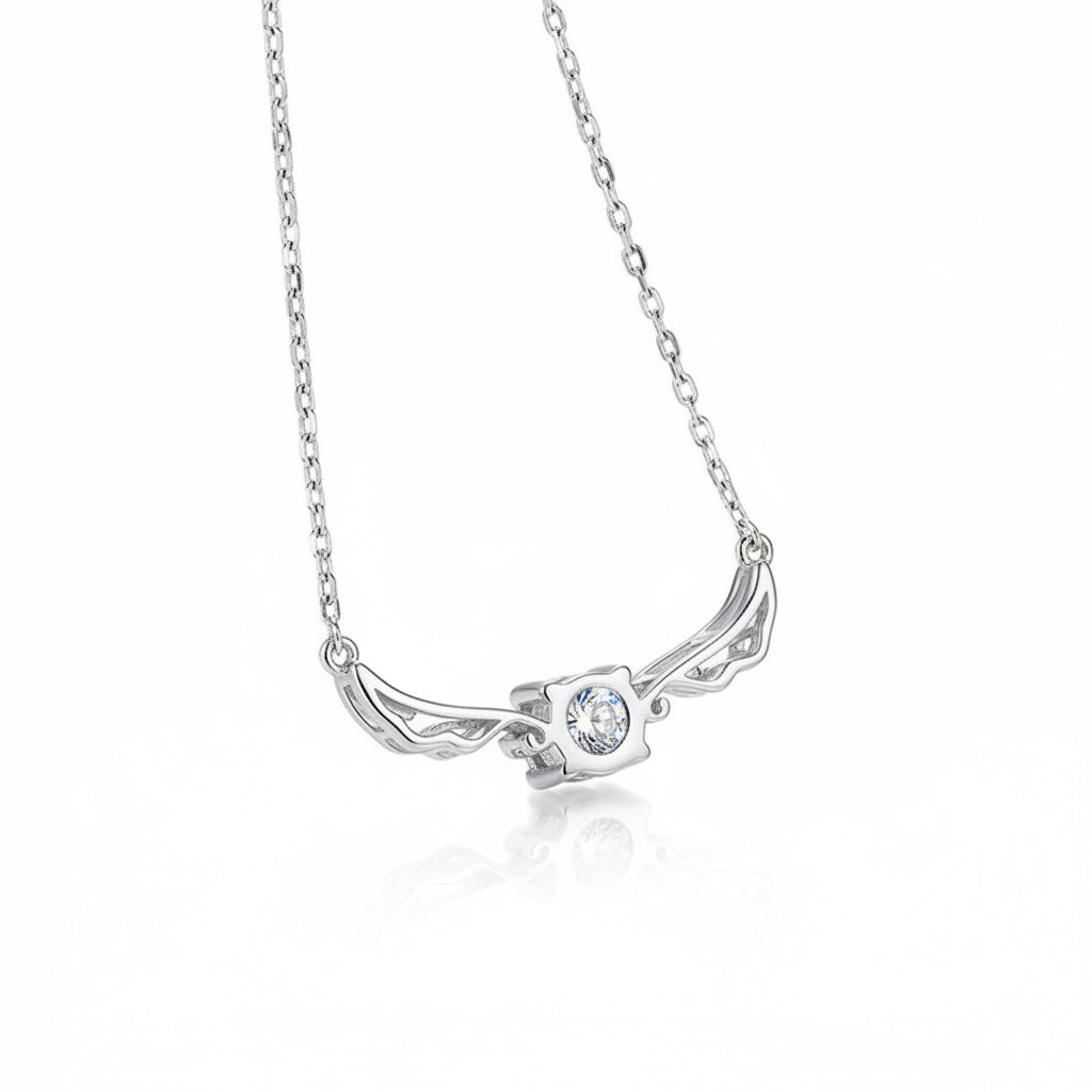 Silver necklace with a winged pendant on a blue textured background angel wing design Silver necklace Aru collection 1 